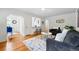 Bright living room with hardwood floors, gray couches, view of the kitchen and dining area at 3346 W 33Rd Ave, Denver, CO 80211