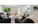 Inviting living room with hardwood floors, gray couches, white door, and a view to the kitchen at 3346 W 33Rd Ave, Denver, CO 80211