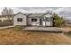 Spacious backyard featuring a concrete patio, lawn, and mature landscaping at 2132 Boise Ct, Longmont, CO 80504