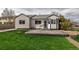 Spacious backyard featuring a concrete patio area and lush green lawn perfect for outdoor entertaining at 2132 Boise Ct, Longmont, CO 80504
