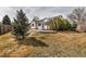 Expansive backyard with mature trees, landscaping, and a patio area, perfect for outdoor entertaining at 2132 Boise Ct, Longmont, CO 80504