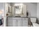 Neutral bathroom with grey vanity, granite counters, mosaic tile accent wall, and modern fixtures at 2132 Boise Ct, Longmont, CO 80504