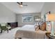 Bright bedroom features plush carpeting, gray walls, a ceiling fan and a window at 2132 Boise Ct, Longmont, CO 80504