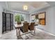 Modern dining room with a large table, chrome legs and stylish light fixture at 2132 Boise Ct, Longmont, CO 80504