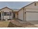 Charming home exterior with brick accents, a walkway, and a two-car garage and well-kept landscape at 2132 Boise Ct, Longmont, CO 80504