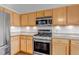 Light wood cabinets and stainless steel appliances adorn this kitchen with granite countertops and wood floors at 2132 Boise Ct, Longmont, CO 80504