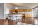 Eat-in kitchen features an island, granite countertops, light wood cabinets and hardwood floors at 2132 Boise Ct, Longmont, CO 80504