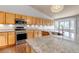 Charming kitchen features a granite countertop island, stainless steel appliances and ample light wood cabinets at 2132 Boise Ct, Longmont, CO 80504