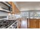 Kitchen with granite countertops, stainless steel appliances, light wood cabinetry, and hardwood floors at 2132 Boise Ct, Longmont, CO 80504