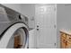 Bright laundry room features modern washer/dryer, ample cabinet space and direct exterior access at 2132 Boise Ct, Longmont, CO 80504