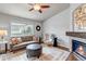 Cozy living room featuring a stone fireplace, hardwood floors, and a comfortable seating area at 2132 Boise Ct, Longmont, CO 80504