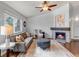 Relaxing living room featuring a stone fireplace, neutral colors, and hardwood floors at 2132 Boise Ct, Longmont, CO 80504