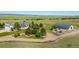 Aerial view of the property featuring the house, barn, and pasture at 10515 Lucas Ave, Franktown, CO 80116