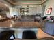 Home bar area with granite countertops, custom cabinetry, and built-in glass shelving for entertaining at 10515 Lucas Ave, Franktown, CO 80116