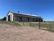 Spacious barn featuring a metal roof, large doors, horse stalls, and fenced enclosure on a picturesque lot at 10515 Lucas Ave, Franktown, CO 80116