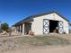 Large barn featuring wide sliding doors, stalls, and functional design, ideal for livestock and equipment at 10515 Lucas Ave, Franktown, CO 80116