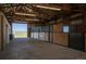 Inside a barn with multiple horse stalls and an open area for storage at 10515 Lucas Ave, Franktown, CO 80116