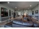 Finished basement has a large sectional sofa, built-ins, and a walkout at 10515 Lucas Ave, Franktown, CO 80116