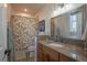 Bathroom featuring a granite countertop, wood cabinets, and shower with a floral shower curtain at 10515 Lucas Ave, Franktown, CO 80116