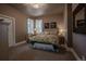 Comfortable bedroom with floral-patterned bedding, desk, and natural light at 10515 Lucas Ave, Franktown, CO 80116