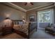 Cozy bedroom features a floral-patterned bedspread and view to the outside at 10515 Lucas Ave, Franktown, CO 80116