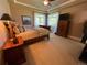 Inviting bedroom with a tray ceiling, ceiling fan, neutral tones, and natural light at 10515 Lucas Ave, Franktown, CO 80116