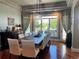 Spacious dining room with hardwood floors, a long table and a modern chandelier at 10515 Lucas Ave, Franktown, CO 80116