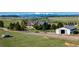 Exterior view of property with barn and mountain backdrop at 10515 Lucas Ave, Franktown, CO 80116