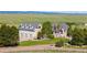 Exterior of the home featuring manicured lawn and three car garage at 10515 Lucas Ave, Franktown, CO 80116