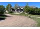 Charming home features a stone and siding exterior, covered porch, and beautifully landscaped front yard at 10515 Lucas Ave, Franktown, CO 80116