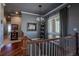 Charming hallway with a decorative stair railing and a view toward multiple rooms at 10515 Lucas Ave, Franktown, CO 80116