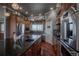 Modern kitchen with dark granite countertops, stainless steel appliances, and ample cabinet space at 10515 Lucas Ave, Franktown, CO 80116