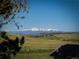 Scenic view of mountains and rolling hills from a large lot of land at 10515 Lucas Ave, Franktown, CO 80116