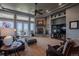 Cozy living room with a stone fireplace, ceiling fan, and comfortable seating, perfect for relaxation at 10515 Lucas Ave, Franktown, CO 80116