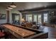 A spacious living room featuring a fireplace and an entertaining shuffleboard table at 10515 Lucas Ave, Franktown, CO 80116