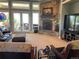 Bright living room featuring a stone fireplace, comfortable seating, and large windows at 10515 Lucas Ave, Franktown, CO 80116