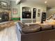 Cozy living room with stone fireplace, custom built-ins, and wood flooring at 10515 Lucas Ave, Franktown, CO 80116