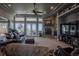 Warm living room featuring a stone fireplace, french doors, and comfortable leather seating at 10515 Lucas Ave, Franktown, CO 80116