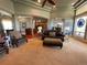 Open-concept living room with leather furniture, archways, hardwood, and neutral color palette at 10515 Lucas Ave, Franktown, CO 80116