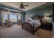 Spacious main bedroom features high ceilings, large windows with scenic views, and elegant furniture at 10515 Lucas Ave, Franktown, CO 80116