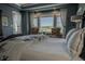 Inviting main bedroom with scenic outdoor views, comfortable seating, and a plush bed at 10515 Lucas Ave, Franktown, CO 80116