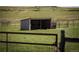Open pasture with loafing shed and gated fencing in a tranquil setting at 10515 Lucas Ave, Franktown, CO 80116