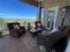 Relaxing covered patio with wicker furniture and a beautiful view of the surrounding landscape at 10515 Lucas Ave, Franktown, CO 80116