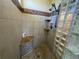 Tiled shower featuring glass blocks, mosaic accents, and built-in shelving at 10515 Lucas Ave, Franktown, CO 80116
