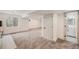 Finished basement featuring neutral carpet, white trim, and door to an unfinished storage area at 9948 King St, Westminster, CO 80031