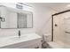 Finished basement bathroom featuring white vanity and shower with glass door at 9948 King St, Westminster, CO 80031