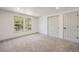 Bright bedroom with carpet floors, two windows, and closet space at 9948 King St, Westminster, CO 80031