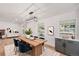 Elegant dining room with modern lighting, stylish furniture, and light hardwood floors at 9948 King St, Westminster, CO 80031
