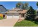 Charming two-story home featuring a two-car garage and well-maintained front lawn at 9948 King St, Westminster, CO 80031