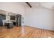 Modern kitchen with stainless steel appliances, a center island, and hardwood floors at 9948 King St, Westminster, CO 80031